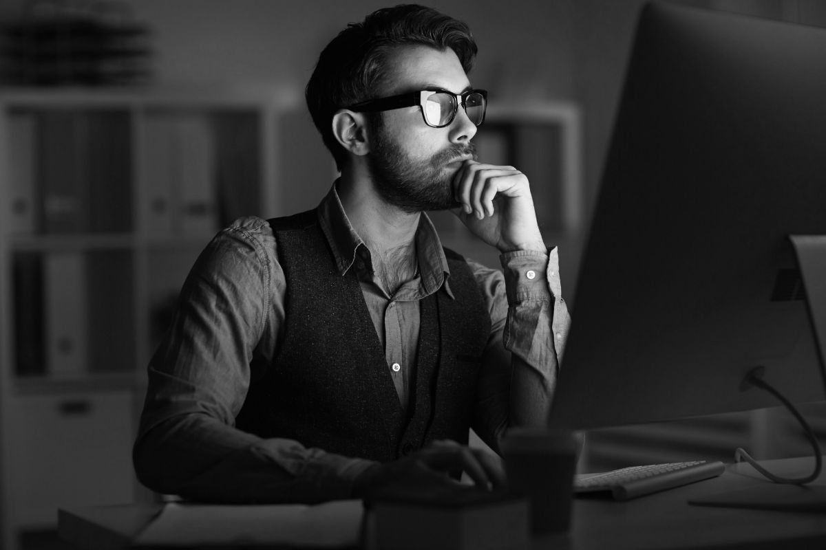 A person sitting at a desk in front of a computer